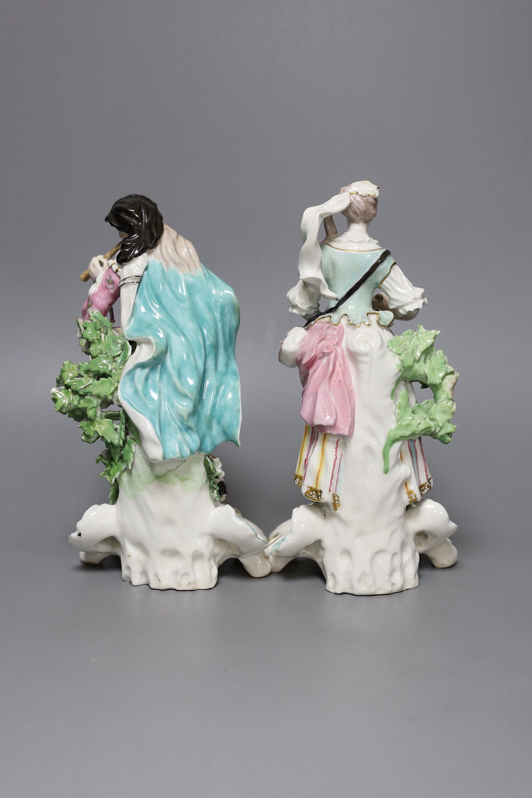 A pair of Derby figures of musicians, he playing the pipe and she playing the triangle, c.1765-70, patch marks, 21cm